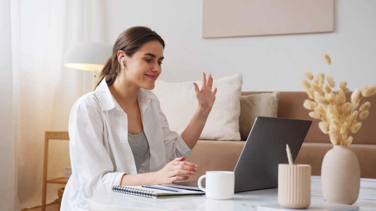 student sitting at desk with laptop