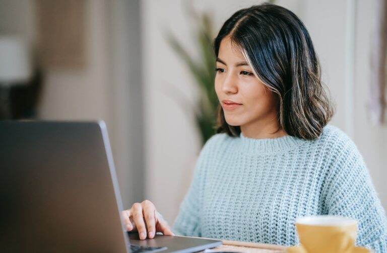 student sitting behind a laptop